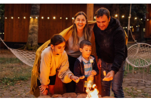 Halal sausages, lamb kebabs and marinated wings grilling outdoors for a Bonfire Night crowd
