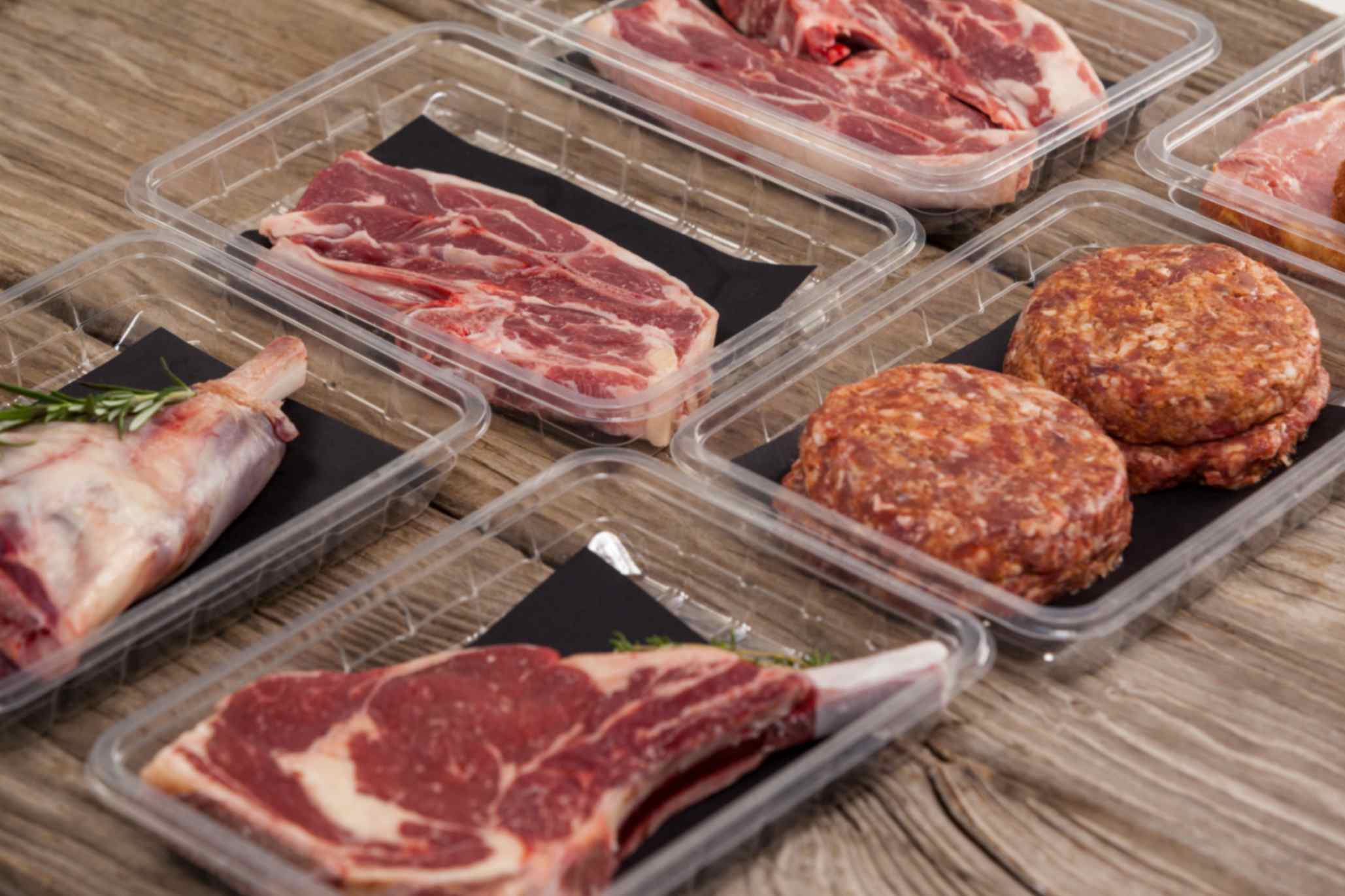 A halal BBQ box of mixed grilling meats laid out beside the same cuts bought separately for a family