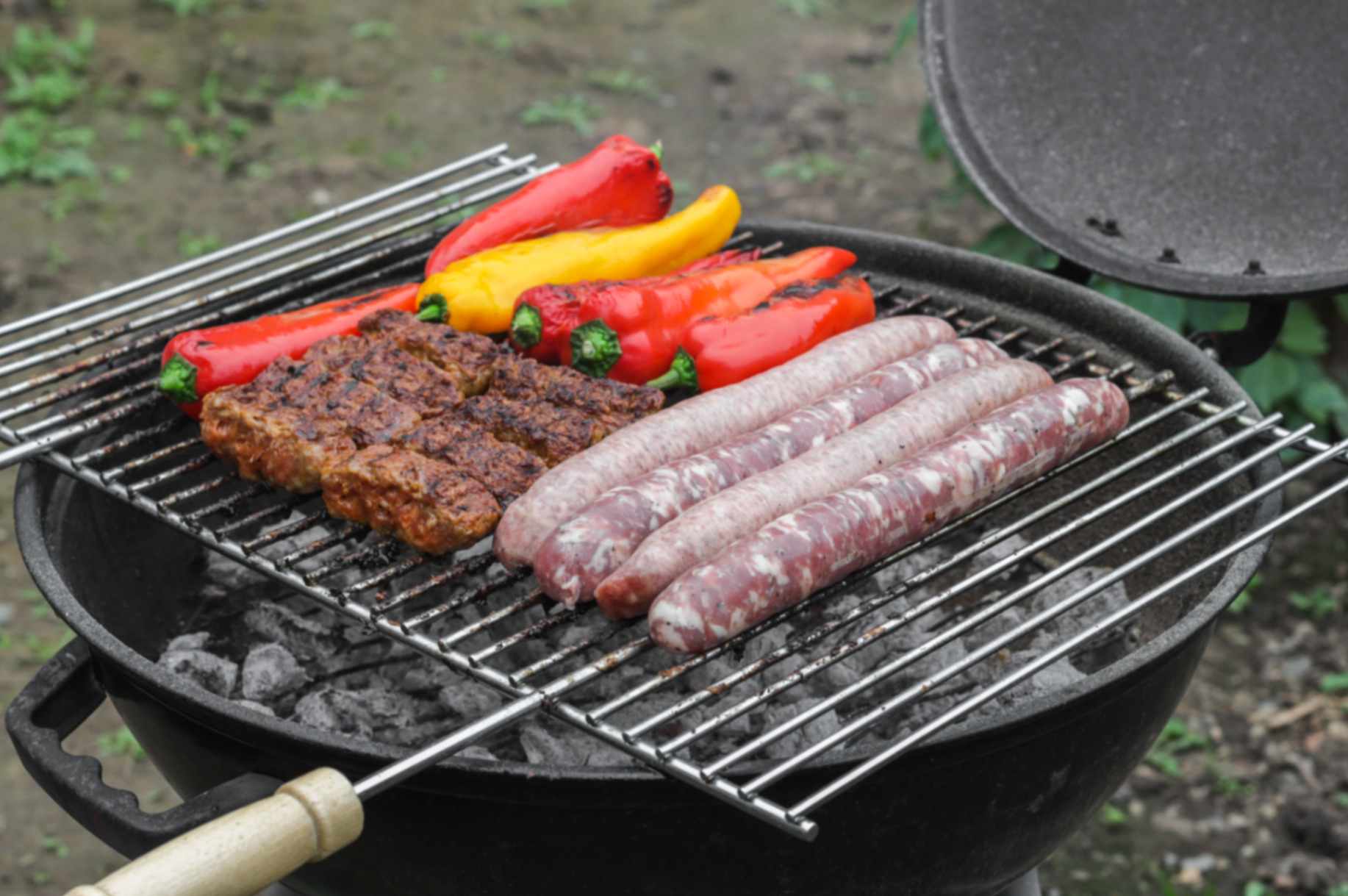 Halal beef and lamb sausages grilling intact over medium heat without splitting