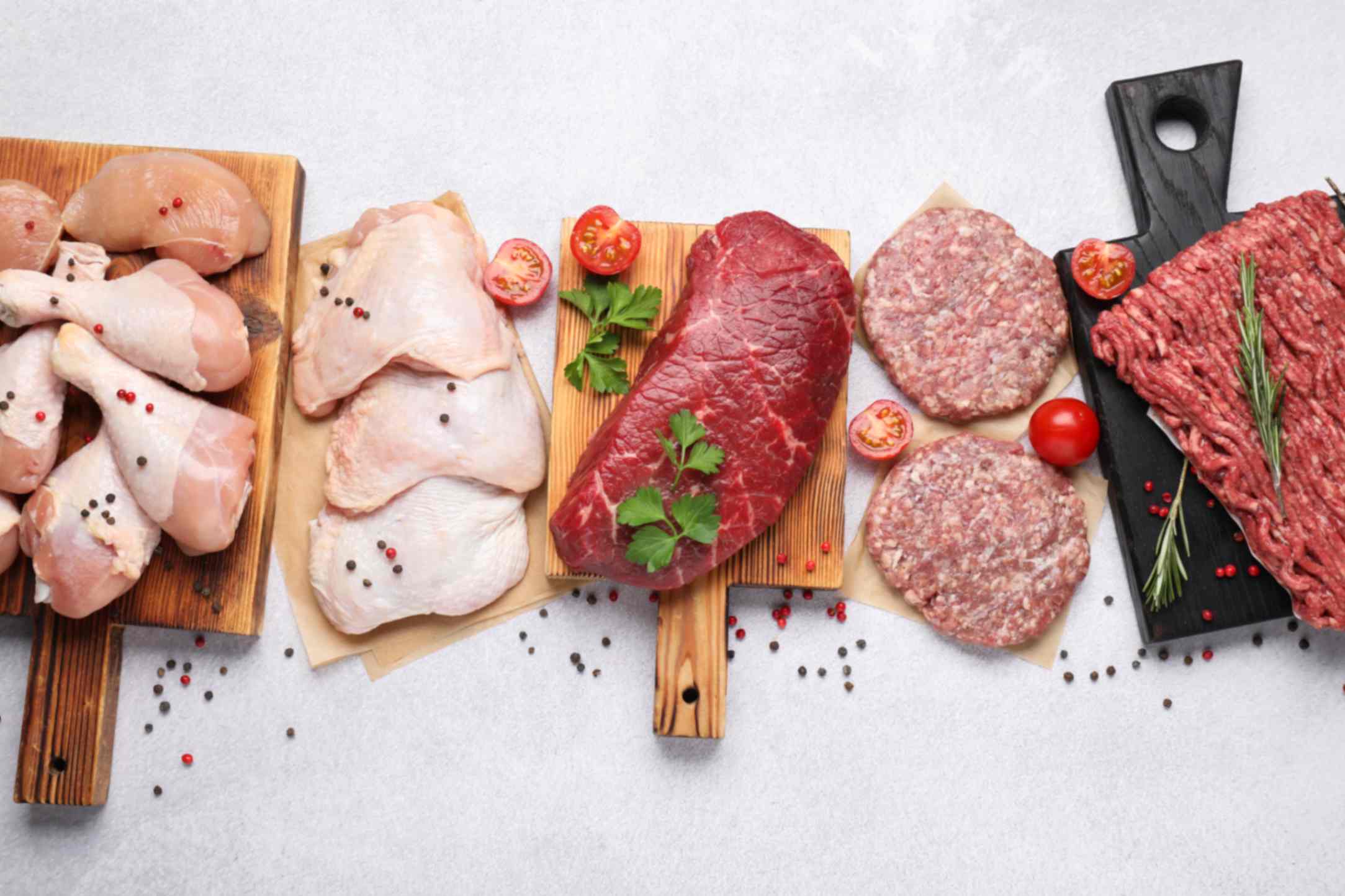 A busy Tariq Halal counter in summer with chicken thighs, lamb chops, sausages and BBQ boxes